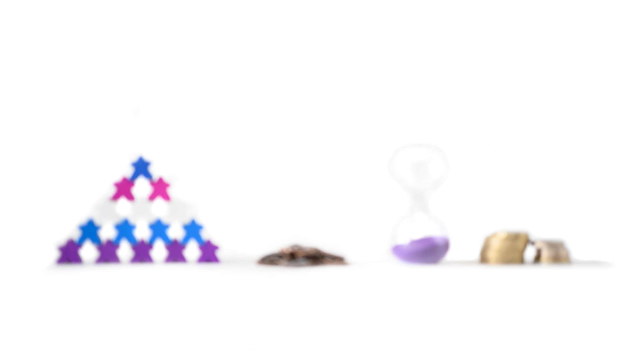 A blurred image showing a pyramid of meeples, metal cogs, an hourglass, and stacked coins, symbolising a lack of clarity around team roles, systems, time, and cash flow
