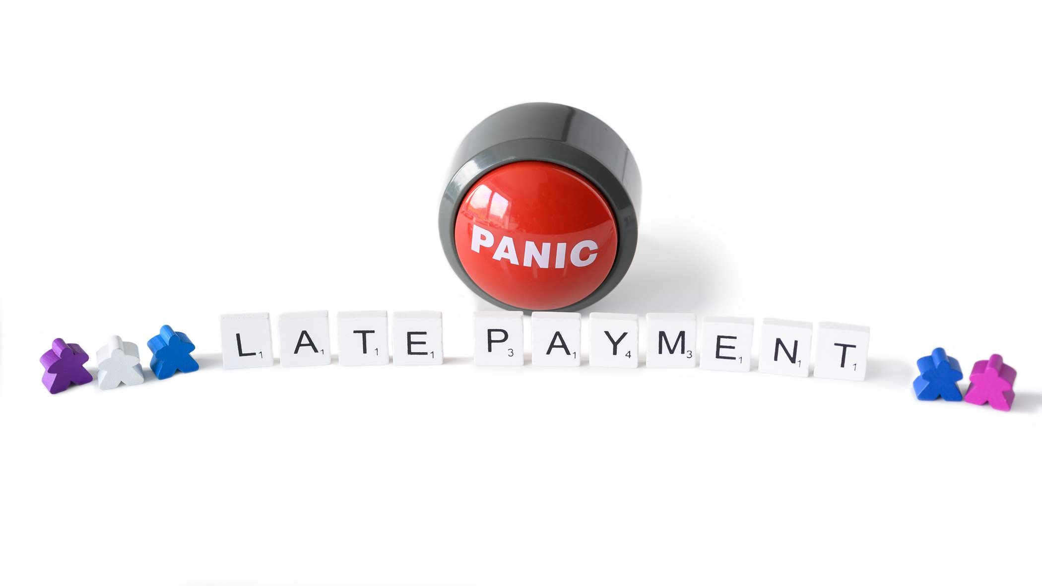 Panic button and the words late payment spelled out in wooden tiles.